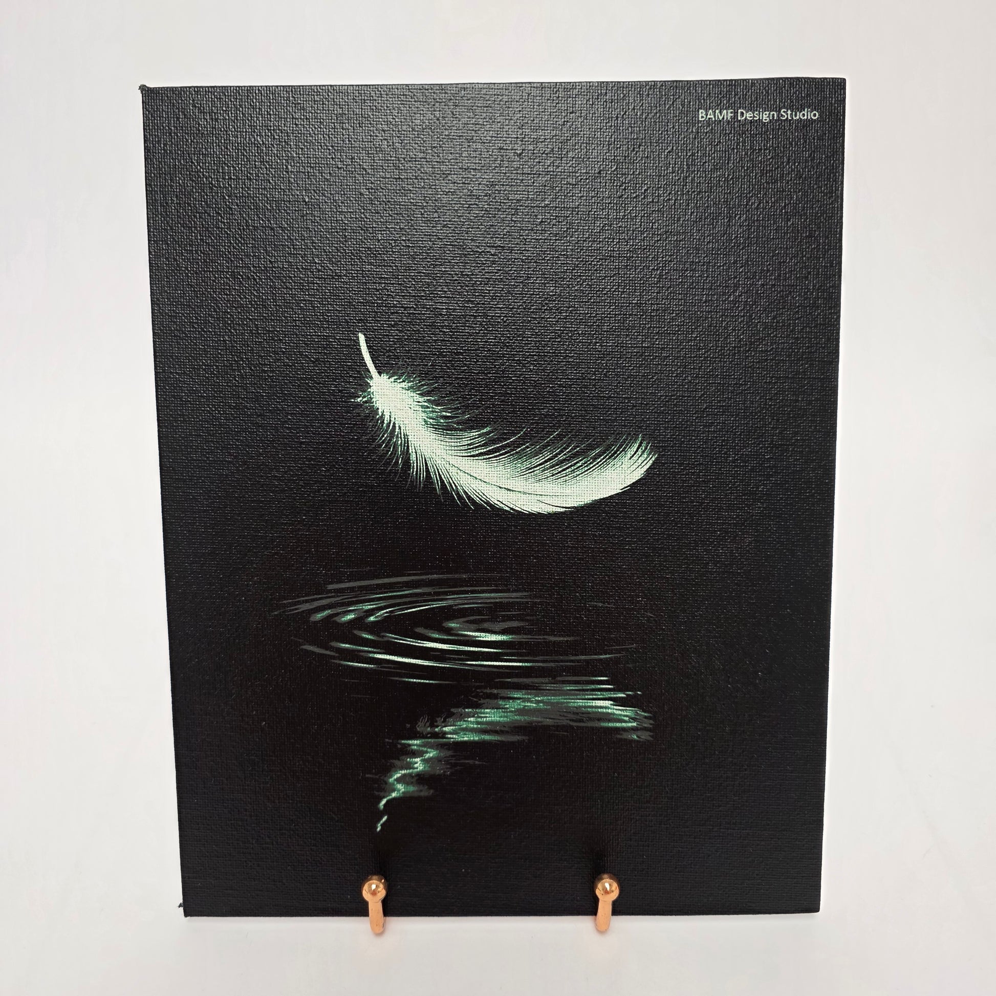 A green feather floating down with a ripple of water beneath it. Black background with green accents.