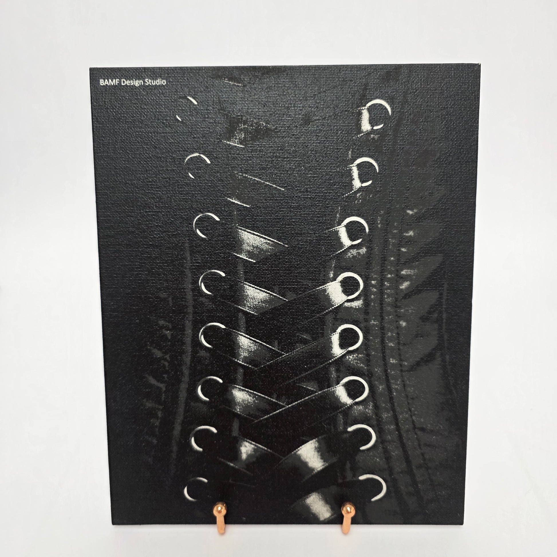 Image of a black and white laced corset printed on canvas.
