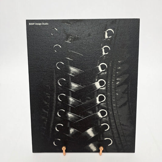 Image of a black and white laced corset printed on canvas.