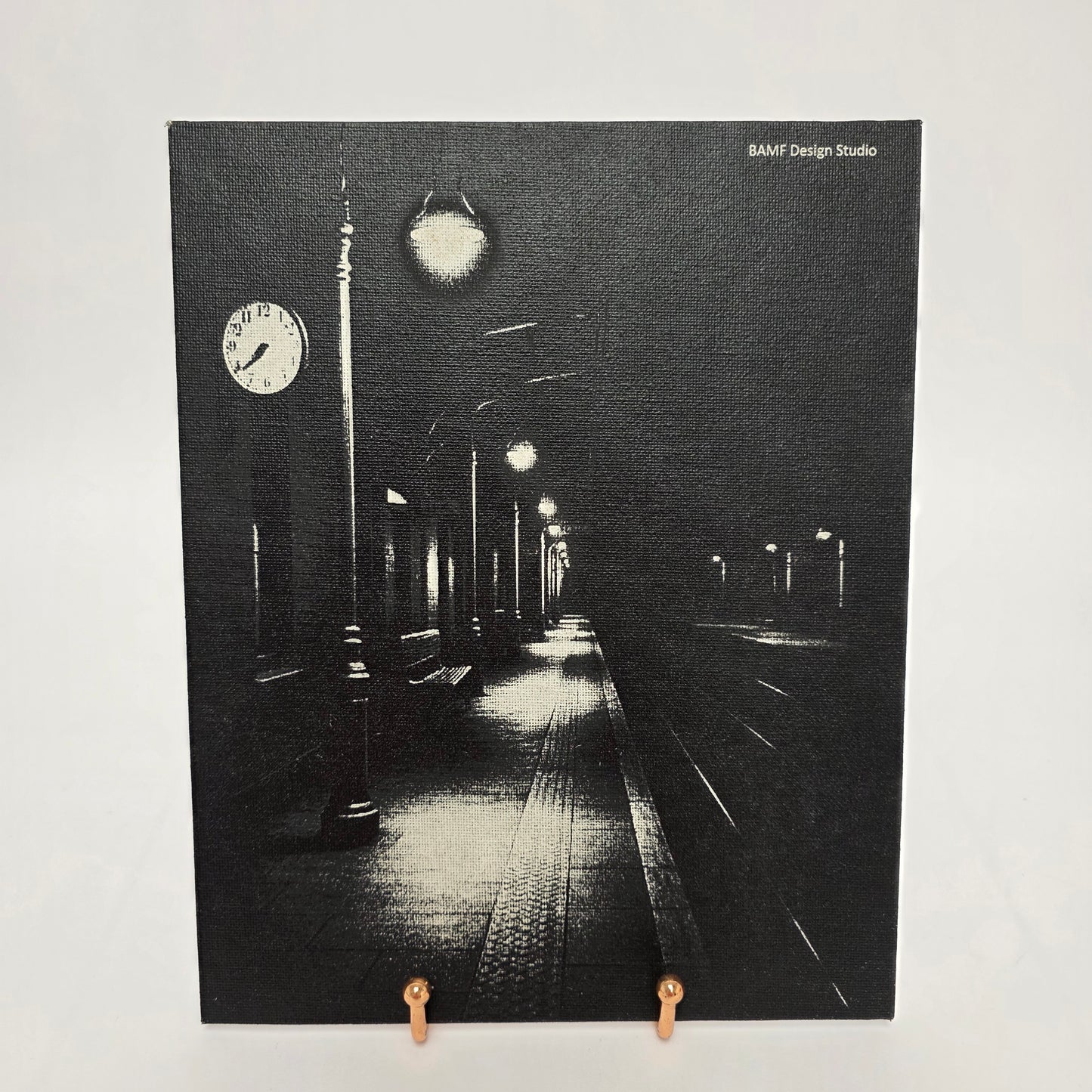 Black and white image of a train station at night. Canvas material.