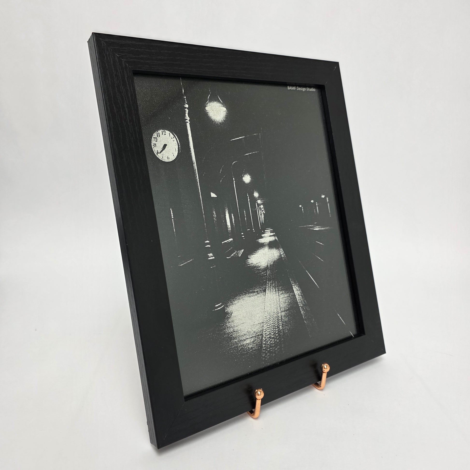 Framed canvas artwork of a black and white image of a train station at night.