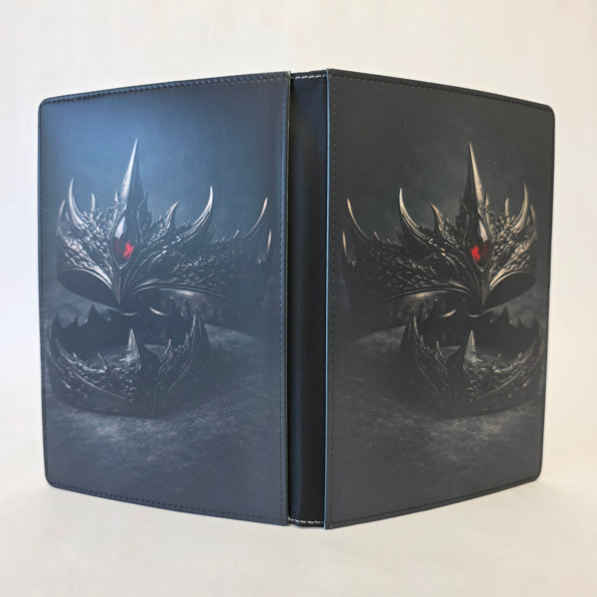 Journal cover featuring iron crowns with dragon scales and a red jewel. Gray background. Image on front and back cover.