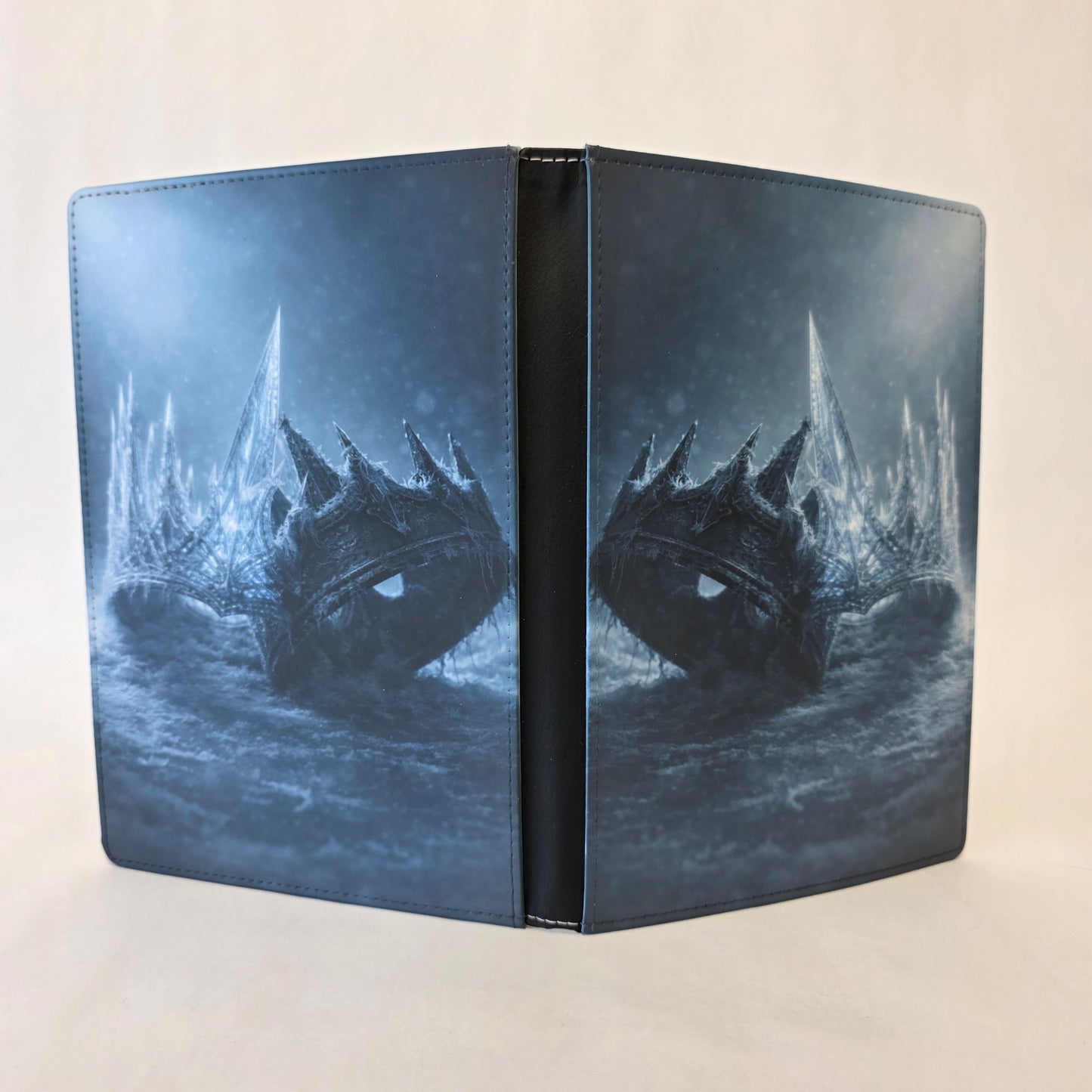 Journal cover featuring a glass crown colliding with an iron crown on both front and back cover.