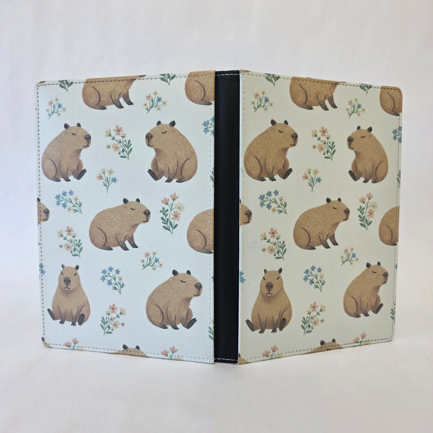 Notebook cover with capybara pattern on a light cream background