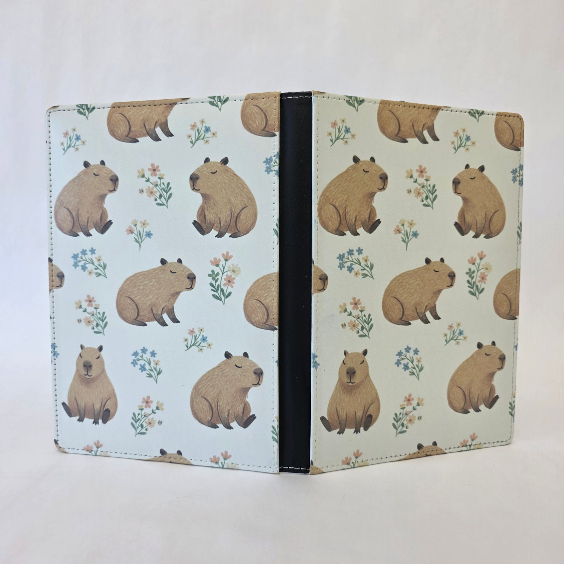 Notebook cover with capybara pattern on a light cream background