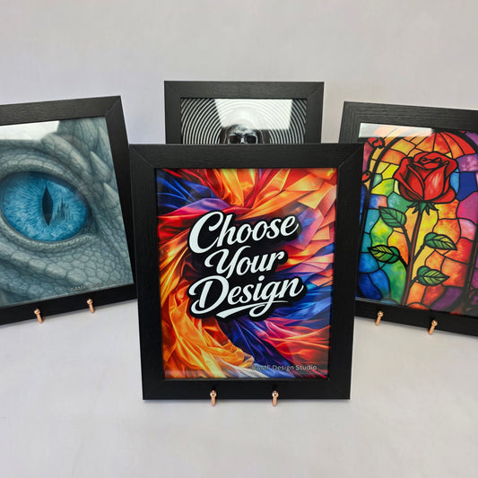Framed artworks with colorful designs on a white table
