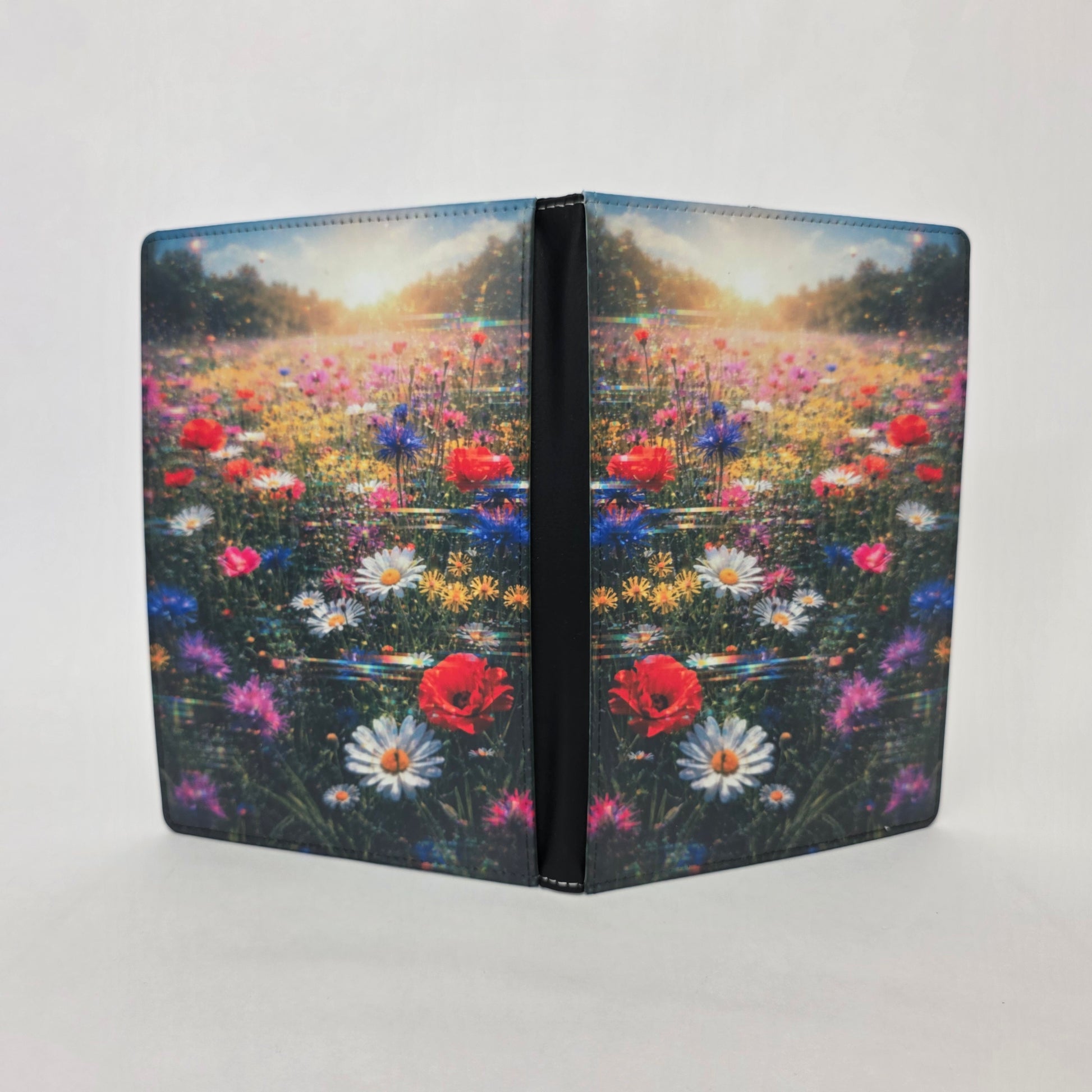 Faux leather journal cover with a field of flowers design on a white background