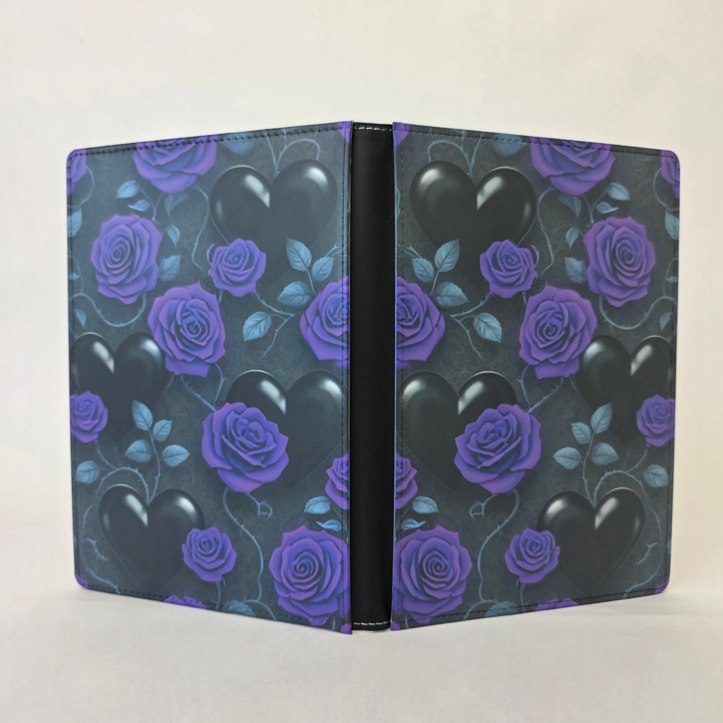 Notebook cover with purple roses and black hearts on a dark background