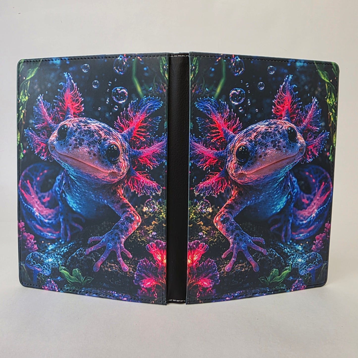 Axolotl with pink and blue accents on a journal cover.