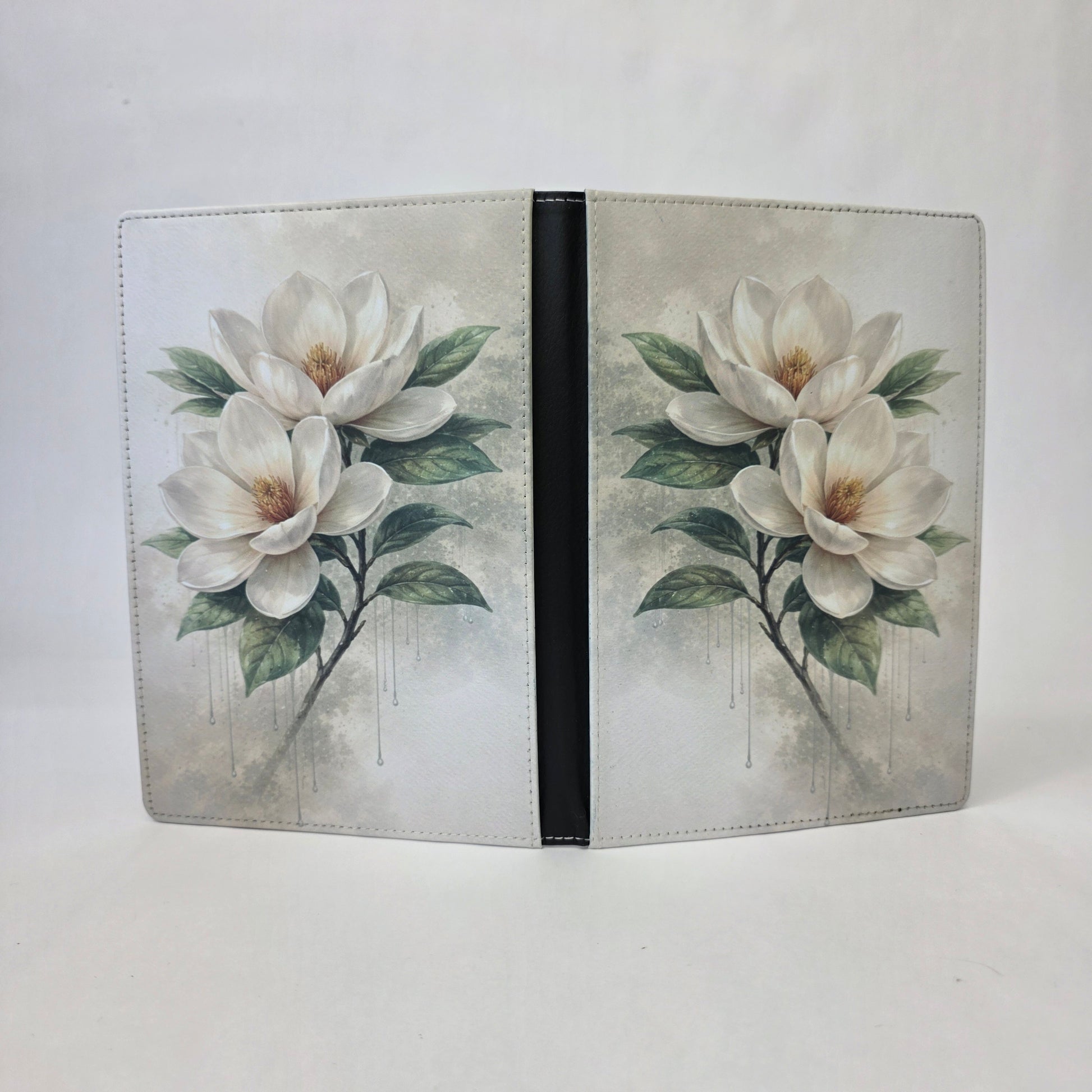 A journal cover with a white magnolia flower.