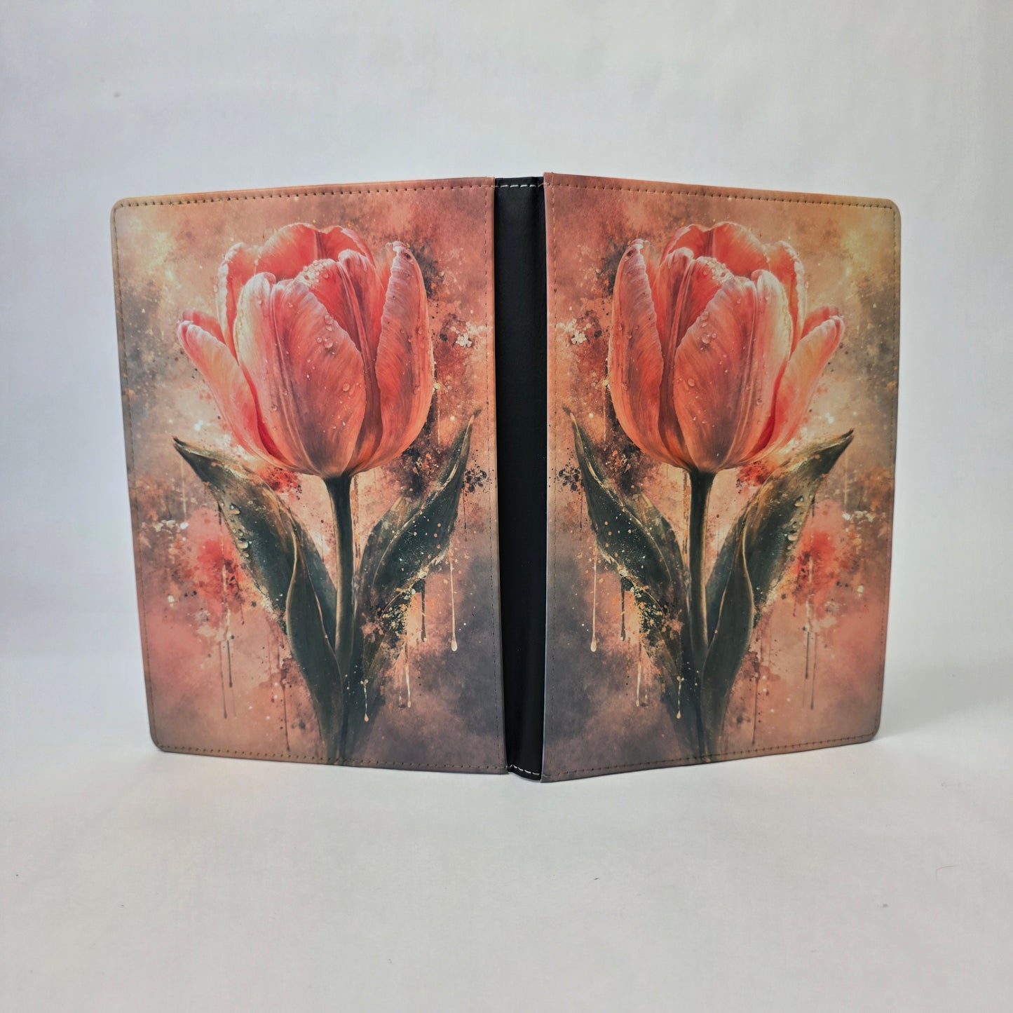 A journal cover with a pink tulip flower.
