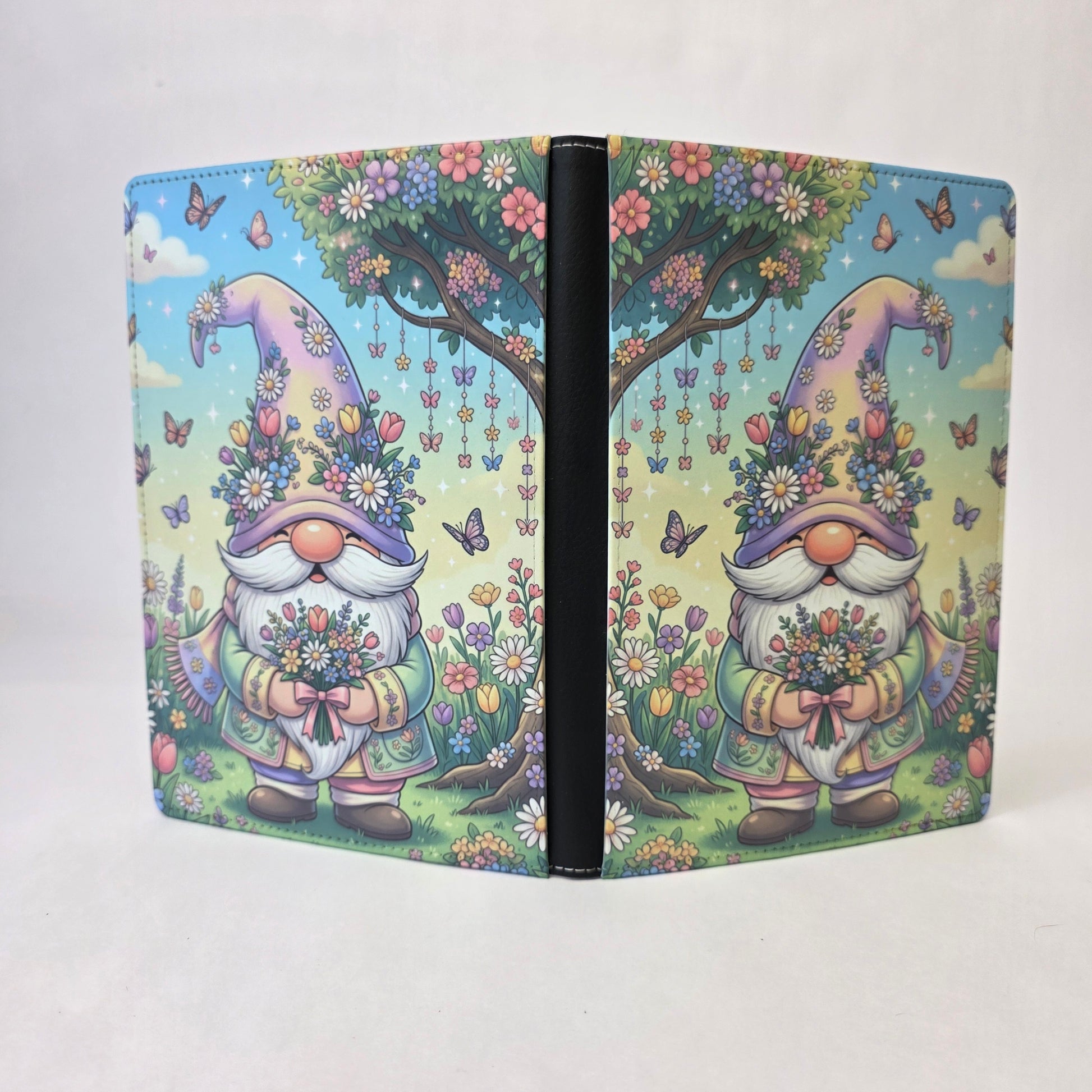 A journal cover with a colorful gnome standing under a tree.