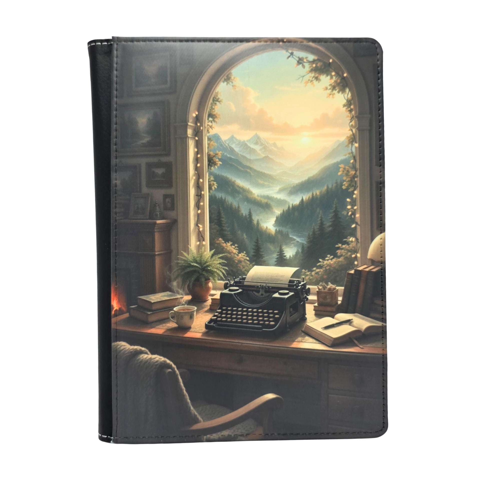 Notebook cover with a typewriter and scenic mountain view design