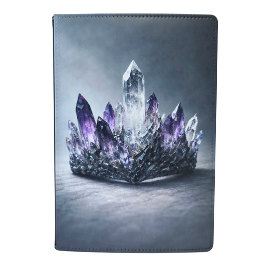 Journal cover with a crown design featuring clear and purple crystals.