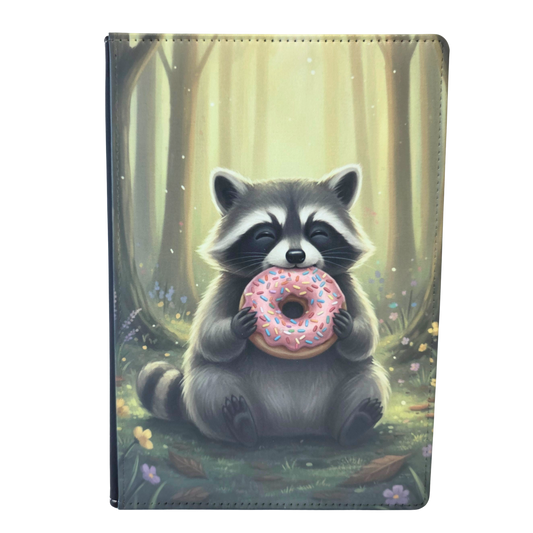 Notebook cover with illustrated raccoon holding a donut with a forest background.