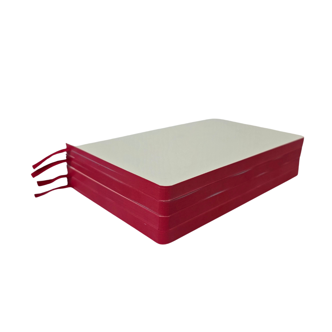 Stack of journal pages showing the red sprayed edge on a white background